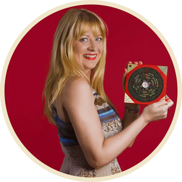 fengshuiportugal.com de Cláudia Machado de Castro com bússola luo pan Feng Shui, fundo vermelho, especialista em Feng Shui Portugal.